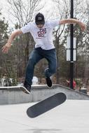 guy jumps on a skateboard on the playground