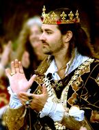 Profile portrait of a man, in the king costume and shiny crown