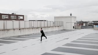 young man doing exercises on the roof