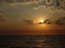 Beautiful waterscape with ripple, at colorful sunrise in the sky with clouds, in Denmark