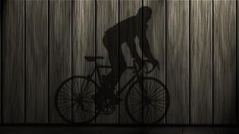 man riding bicycle, shadow on wooden planks, drawing