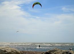 kitesurfing by the rocky ocean coast