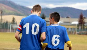 captain with football team player on the field