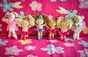 different little dolls on a colorful background