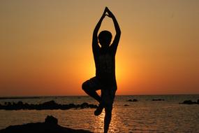 Yoga, Person Balancing in front of sea at sunset
