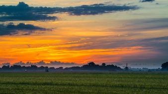 colorful twilight over green field
