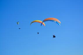 three Paragliders in Blue sky