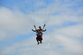 paratrooper in flight at blue sky background with white clouds