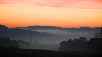 Beautiful landscape with the fog, at colorful sunrise in the morning