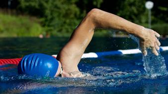 athlete swims in the pool outdoors