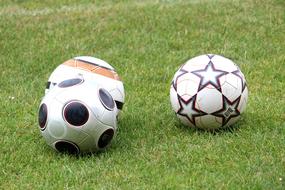 Colorful, shiny football balls, on the green grass, on the lawn