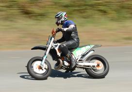 an athlete at speed rides a motorcycle during a race