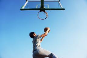 basketball player jumping near baskets