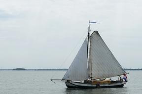photo of a sailing ship going in the wind