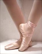 pink pointe shoes on ballerina's legs