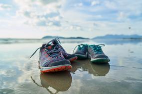shoes on the water on the beach