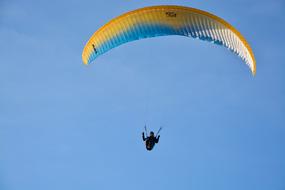 Paragliding, person beneath colorful at bluey