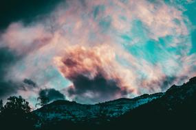 landscape of the clouds over the mountains look like candy floss
