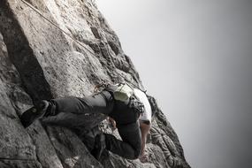 man climbing on rock