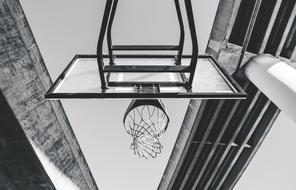 basketball hoop among concrete architecture