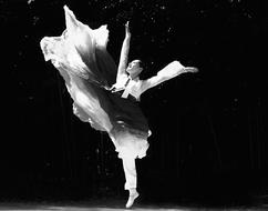 Black and white photo of the beautiful, dancing woman, at black background, clipart