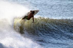 a man on a surfboard riding the waves