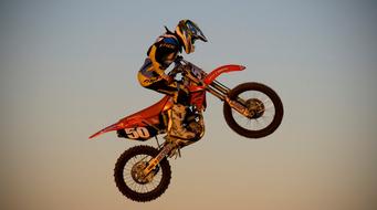 an athlete in a helmet performs an extreme stunt