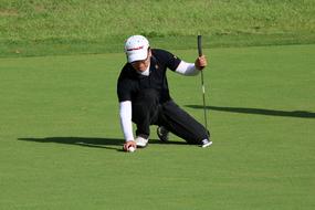 male player kneeling on Golf Course