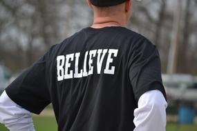 white inscription on a t-shirt of a young man