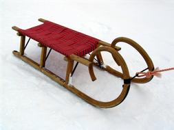 wooden sleigh on white snow