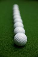 white Golf Balls on green surface