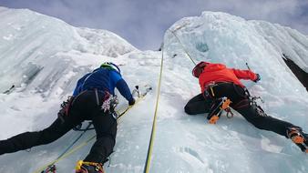two ice climbers on a rock close up
