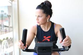 photo of brunette on an exercise bike