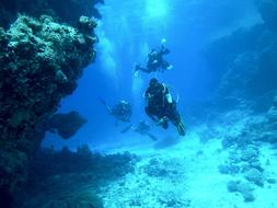 diving in the blue water among the stones