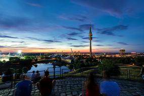 Panoramic view of olympia tower and stadium in city at dusk, germany, munich
