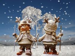 figurines of christmas deer on a background of snowflakes