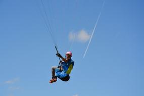 a man with a parachute in the blue sky
