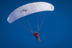 white parachute in the blue sky