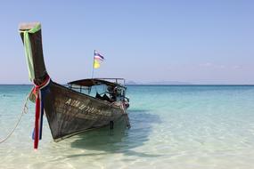 moored traditional boat on water, Thailand