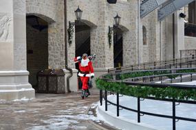 santa claus with skis among urban architecture