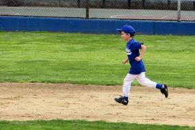 Little League Baseball in blue uniform