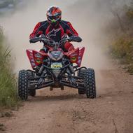 quad racer speeding on soil road
