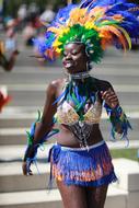 Woman in the beautiful and colorful Caribbean Costume, on the road