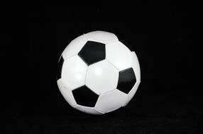 white soccer ball on black background