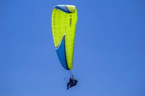 Paraglide in a clear blue sky on a sunny day