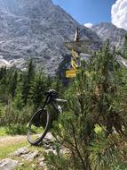 the bike is parked at the foot of the mountain