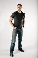 photo of a man in jeans and a black t-shirt