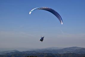 Paragliding, Glider at Sky above green mountains at dusk