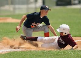 Baseball Players in action on the green grass and sand