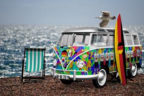 bus painted for Football World Cup 2018 on beach at sea, collage